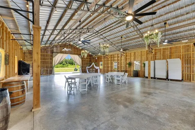 an aerial view of a house with swimming pool garden and patio