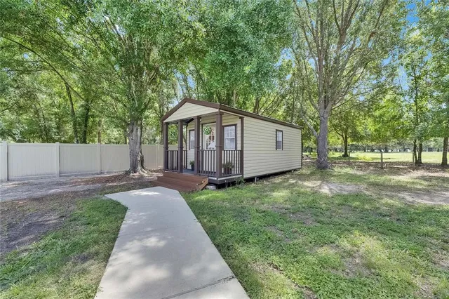 a view of a dining room with furniture a livingroom and chandelier
