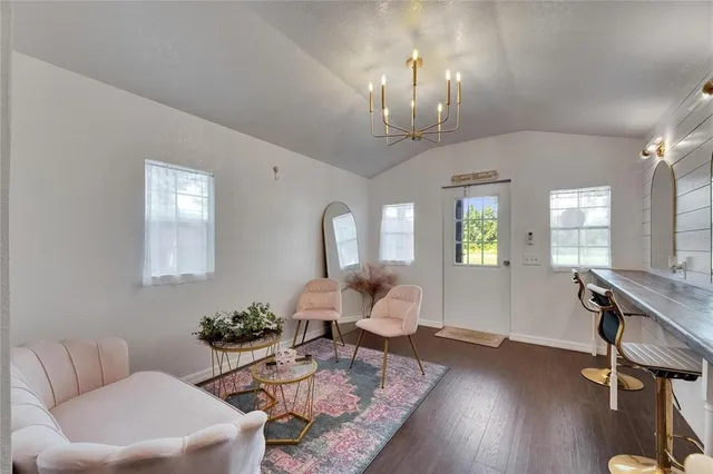 a living room with furniture a rug and a large window