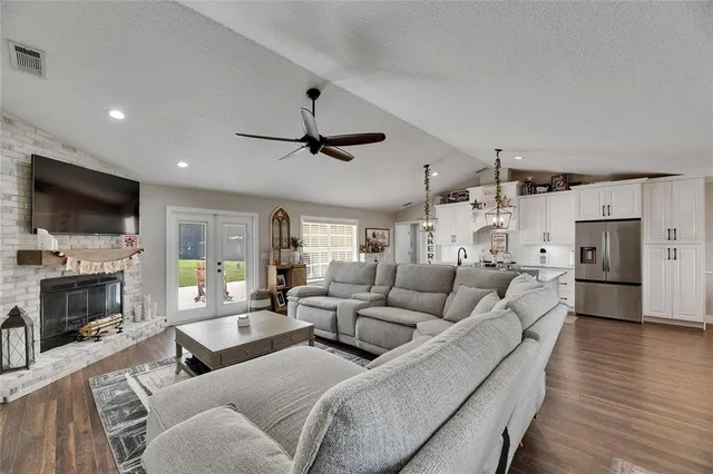a living room with furniture a fireplace and a flat screen tv