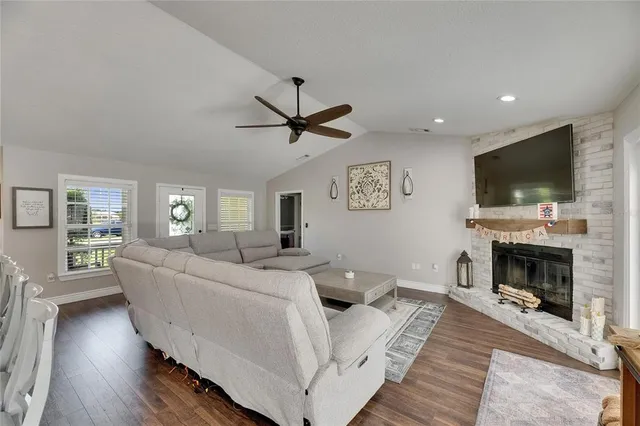 a living room with furniture a fireplace and a flat screen tv