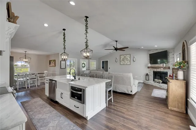 a bedroom with a bed a flat screen tv and a chandelier