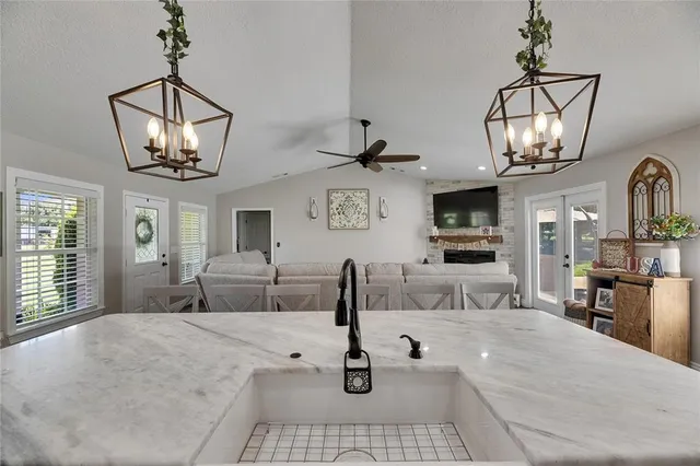 a bedroom with a large bed and a chandelier