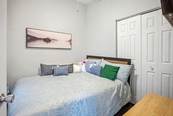 a bedroom with a bed and cupboard