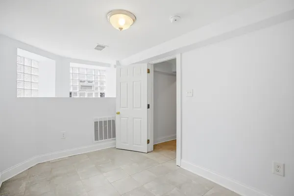 an empty room with windows and closet