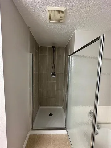 a bathroom with a shower and a sink