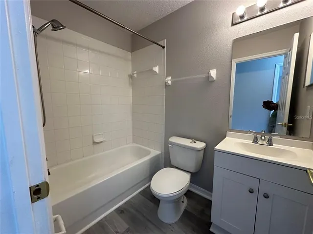 a bathroom with a sink mirror vanity and toilet
