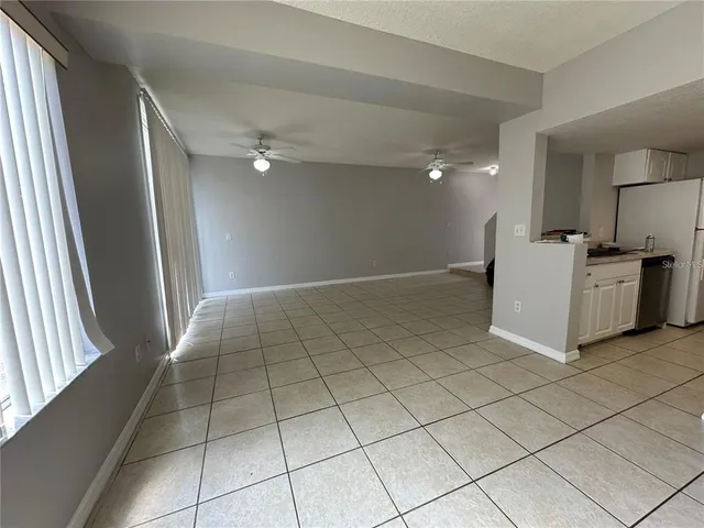 a view of a kitchen with a sink and a refrigerator