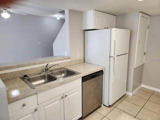 a white refrigerator freezer sitting inside of a kitchen