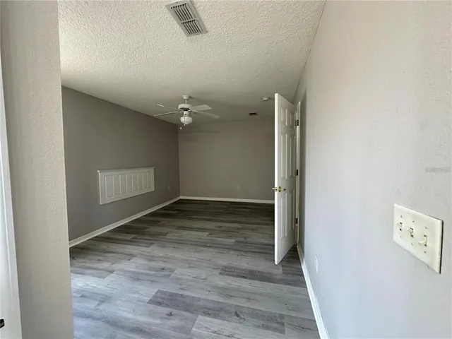 an empty room with wooden floor