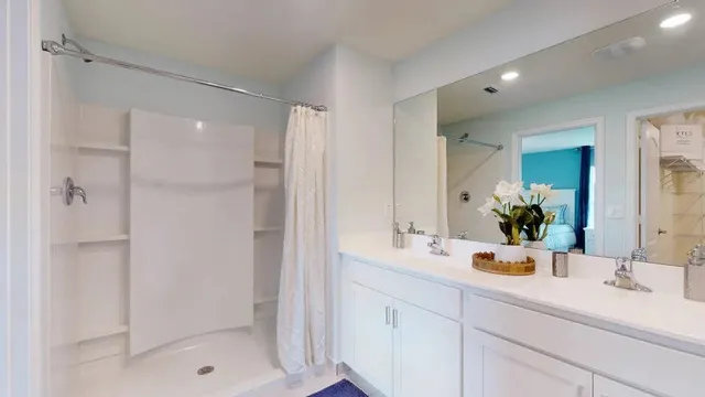 a bathroom with a shower sink and mirror
