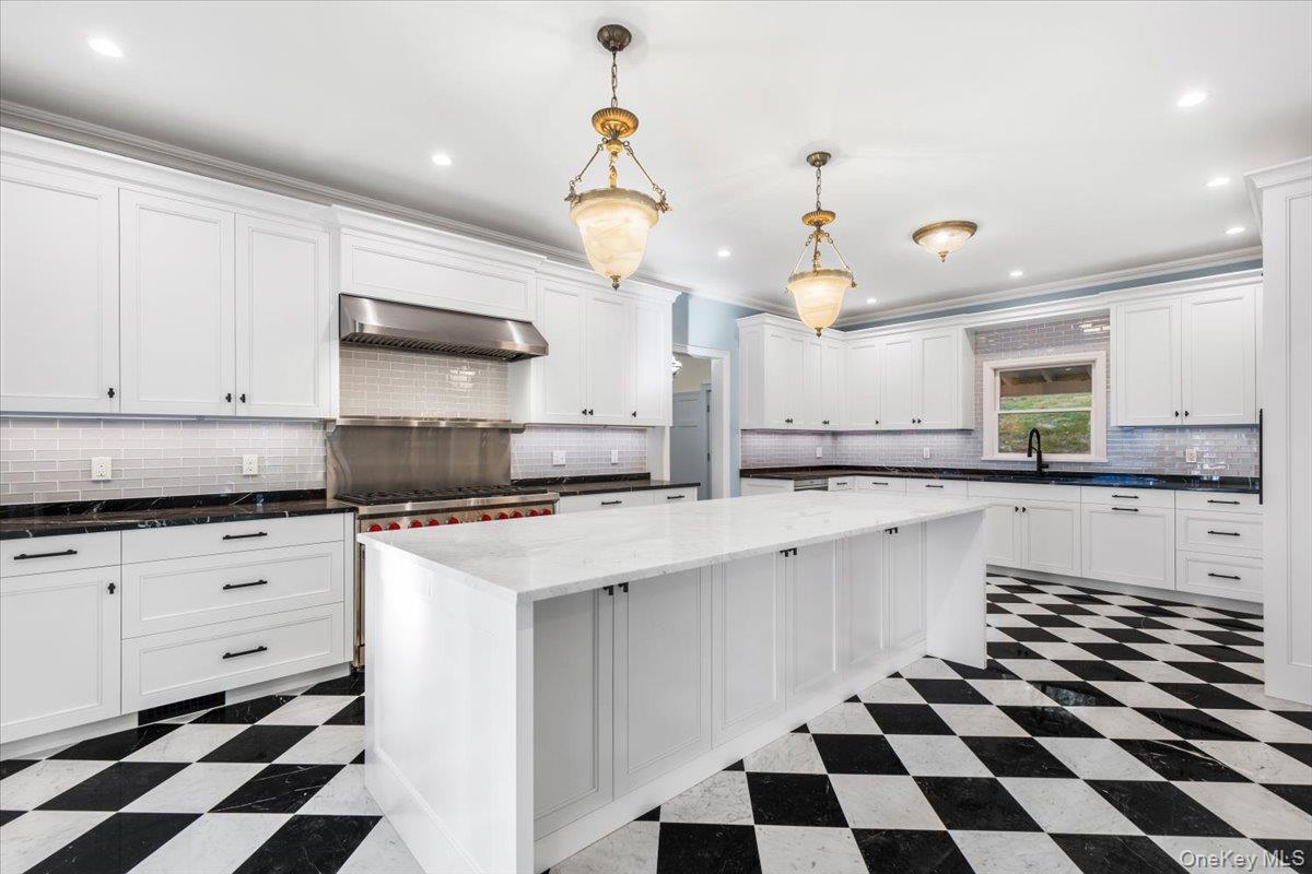 83 Somerstown Road Ossining, NY 10562 - Photo 12 of 38 a kitchen with a sink a stove a microwave and cabinets