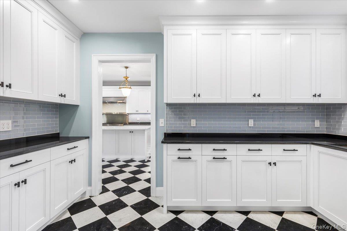 83 Somerstown Road Ossining, NY 10562 - Photo 15 of 38 a kitchen with granite countertop white cabinets and stainless steel appliances