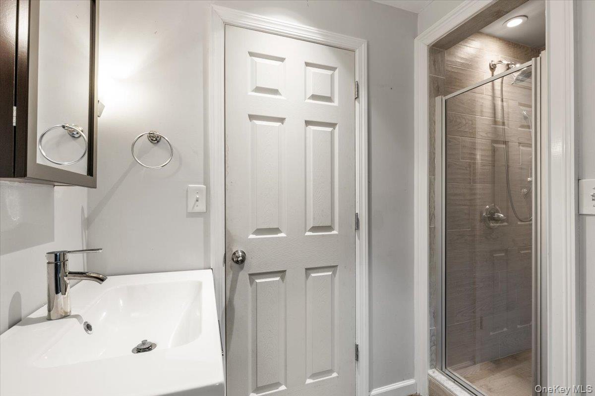 83 Somerstown Road Ossining, NY 10562 - Photo 27 of 38 Guest Apartment -A crisp full bath with glass shower stall, vanity, and clean finishes.