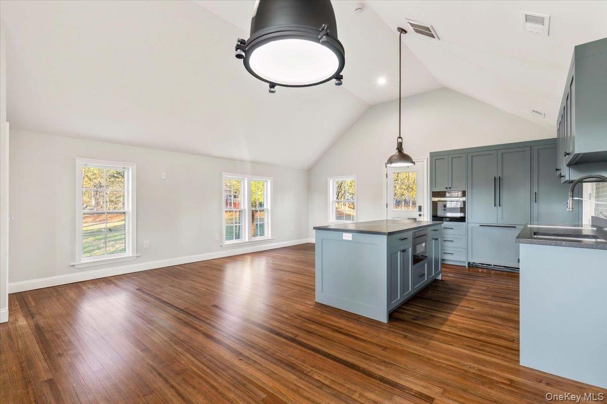 83 Somerstown Road Ossining, NY 10562 - Photo 38 of 38 a kitchen with stainless steel appliances granite countertop a sink a stove and wooden floors
