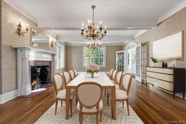 a dining room with furniture a chandelier and wooden floor