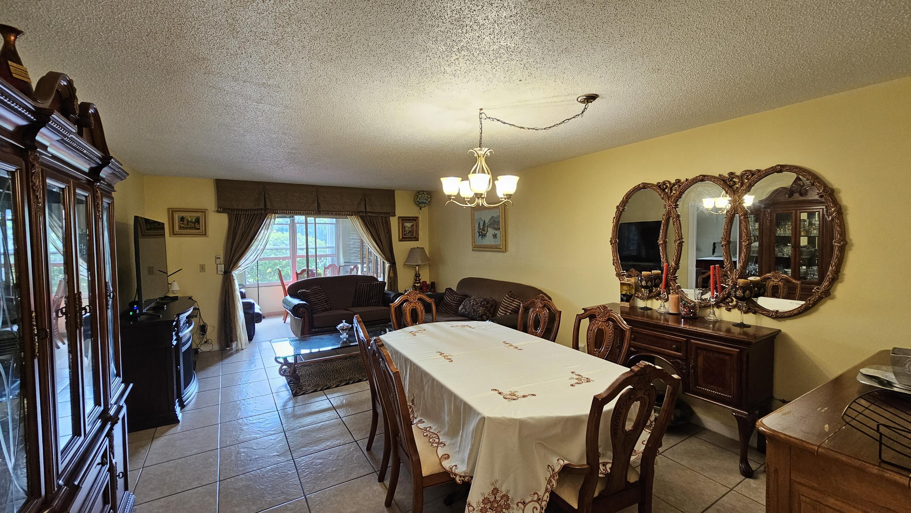 a dining room with furniture and a chandelier