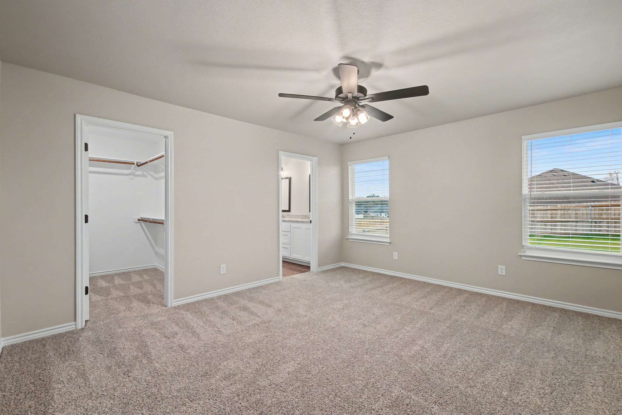 206 Water Wl Road Burnet, TX 78611 - Photo 10 of 25 Soft carpeting pairs with classic trim in this main suite featuring an attached bath.