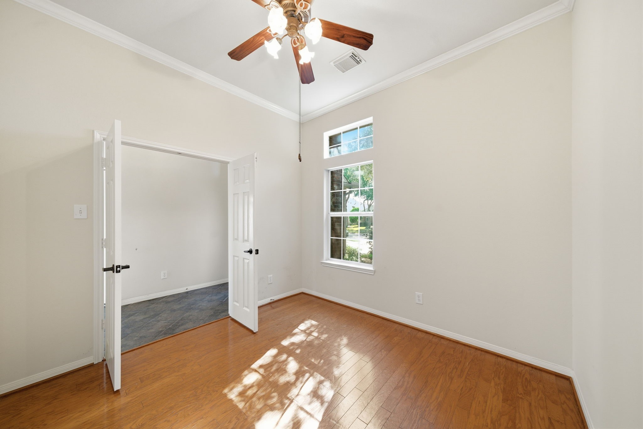 17714 Sunset River Lane Houston, TX 77084 - Photo 11 of 20 wooden floor in an empty room with a window