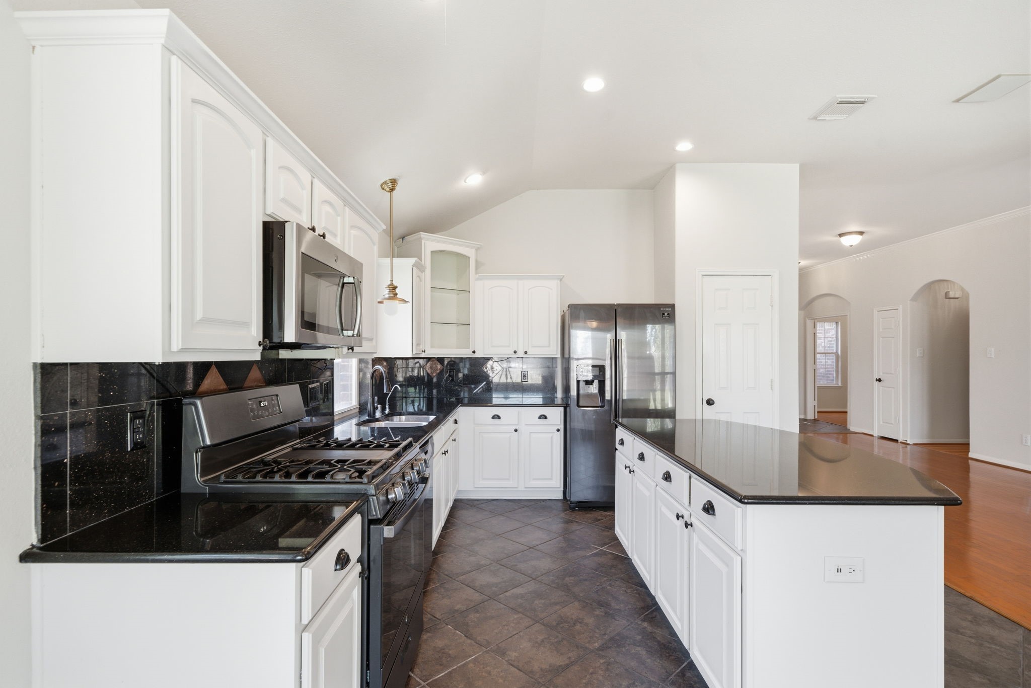 17714 Sunset River Lane Houston, TX 77084 - Photo 5 of 20 a kitchen with a sink stove top oven and cabinets