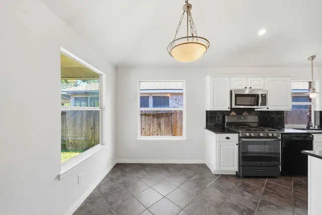 a kitchen with a stove and a microwave