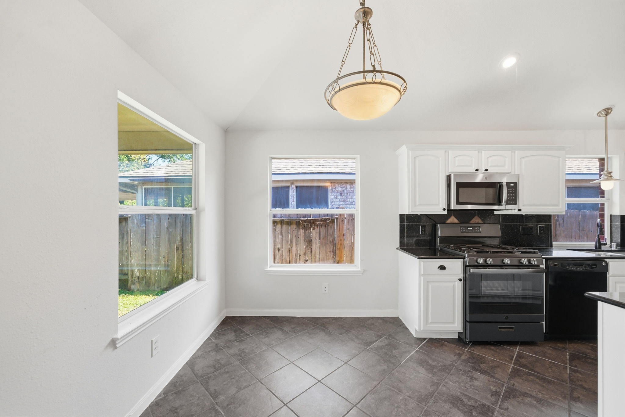 17714 Sunset River Lane Houston, TX 77084 - Photo 6 of 20 a kitchen with a stove and a microwave
