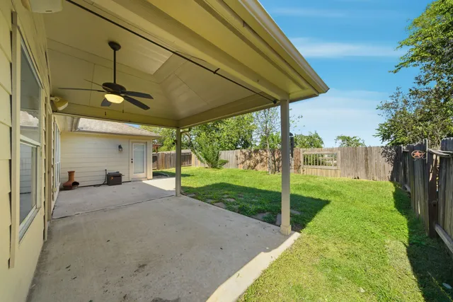 a view of a porch with furniture and garden