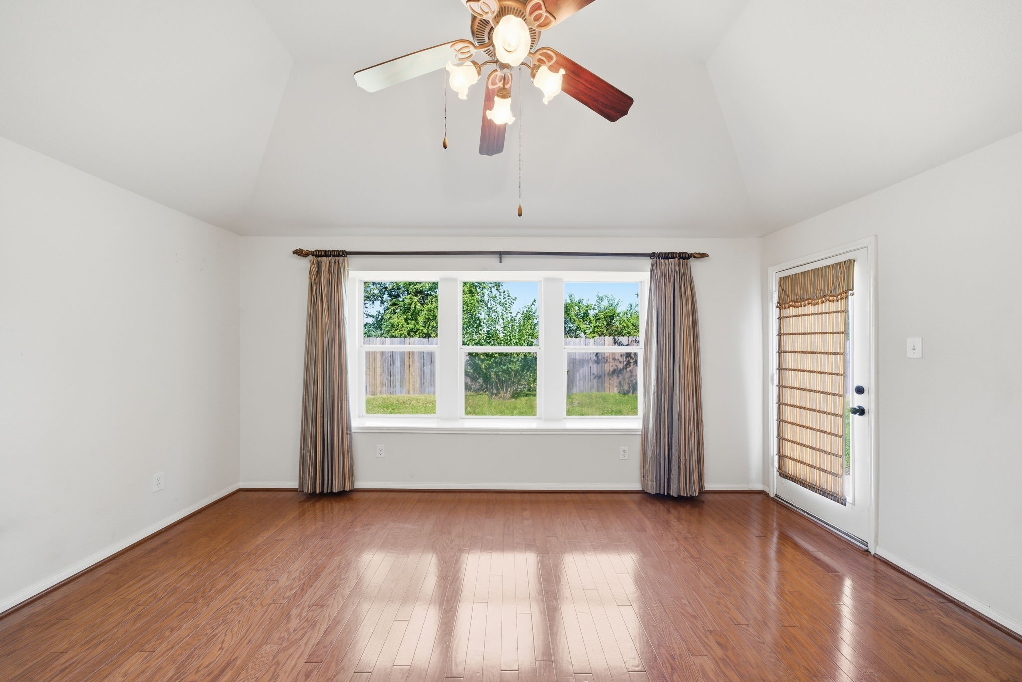 17714 Sunset River Lane Houston, TX 77084 - Photo 8 of 20 a view of an empty room with wooden floor and a window