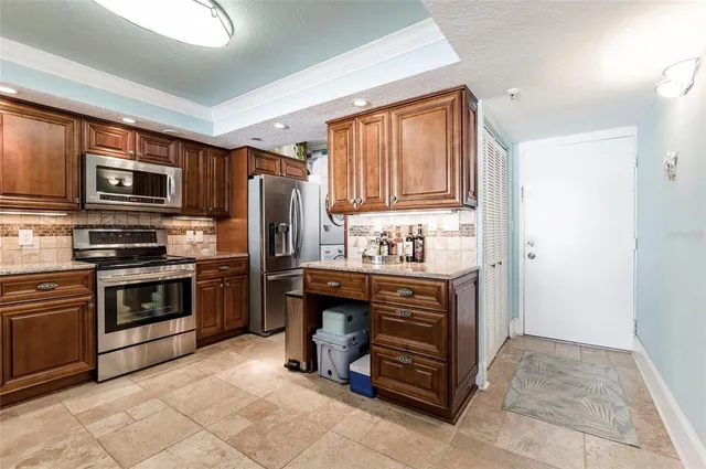 a kitchen with stainless steel appliances granite countertop a refrigerator stove and sink