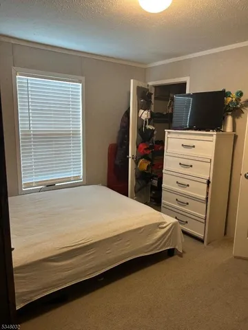 a bedroom with a bed and furniture
