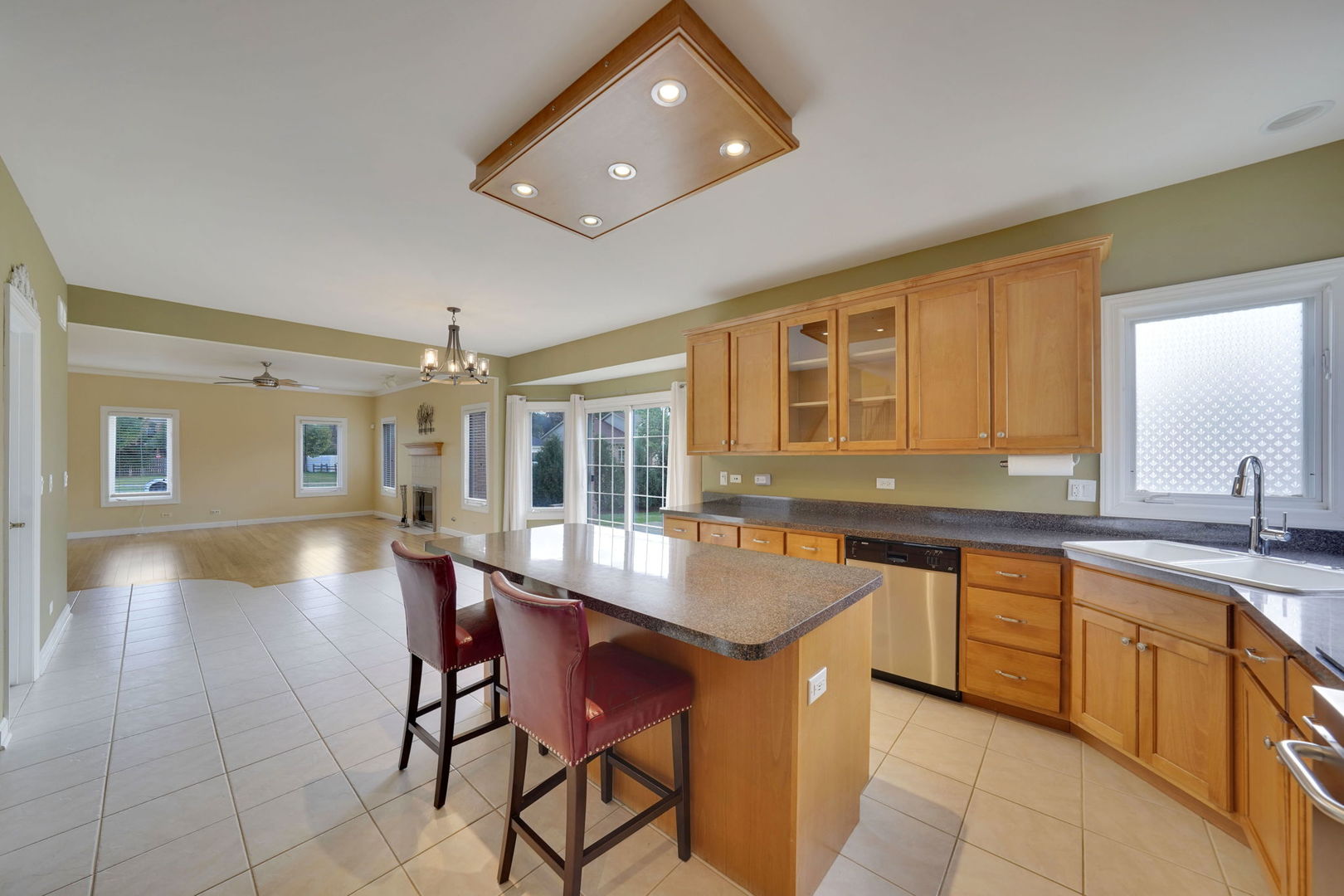 801 West Veterans Parkway Addison, IL 60101 - Photo 17 of 42 a dining hall with stainless steel appliances granite countertop a dining table and chairs with wooden floor