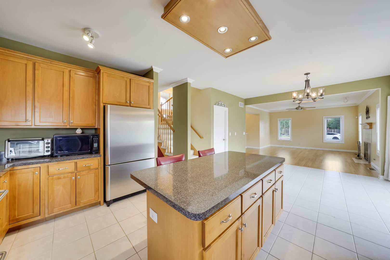 801 West Veterans Parkway Addison, IL 60101 - Photo 18 of 42 a kitchen with kitchen island granite countertop a sink a counter top space appliances and cabinets