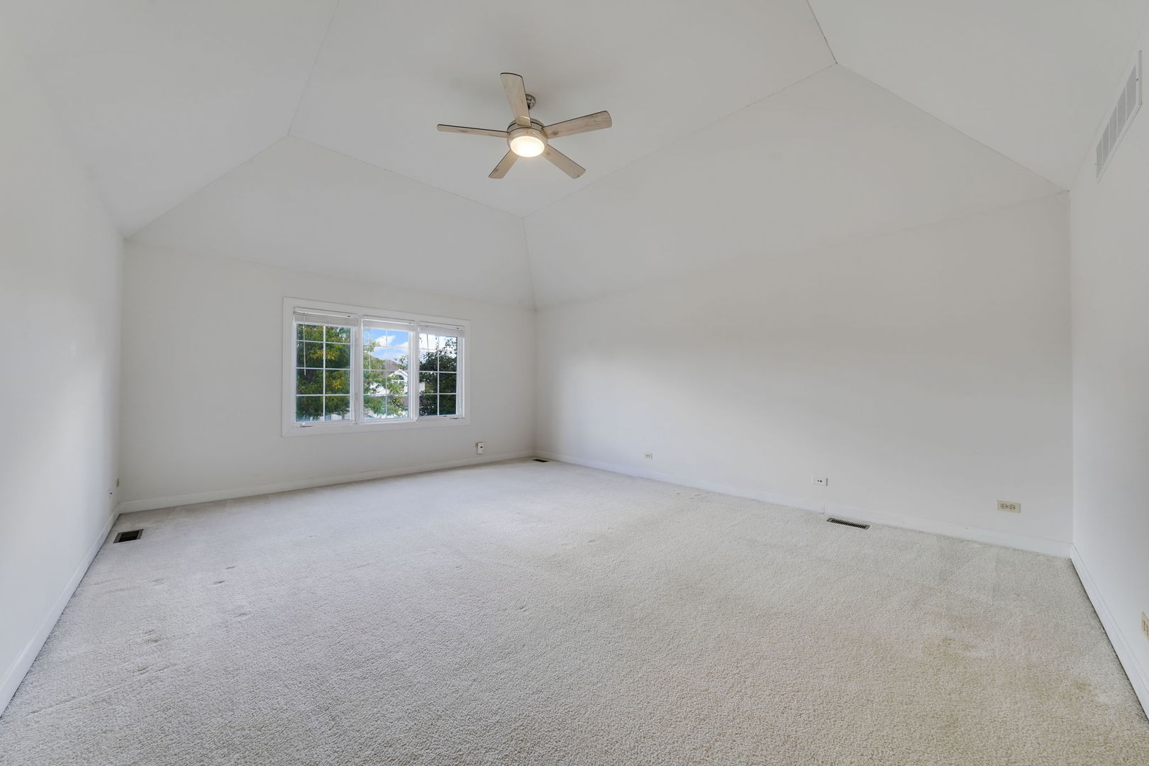 801 West Veterans Parkway Addison, IL 60101 - Photo 21 of 42 an empty room with a fan and a window