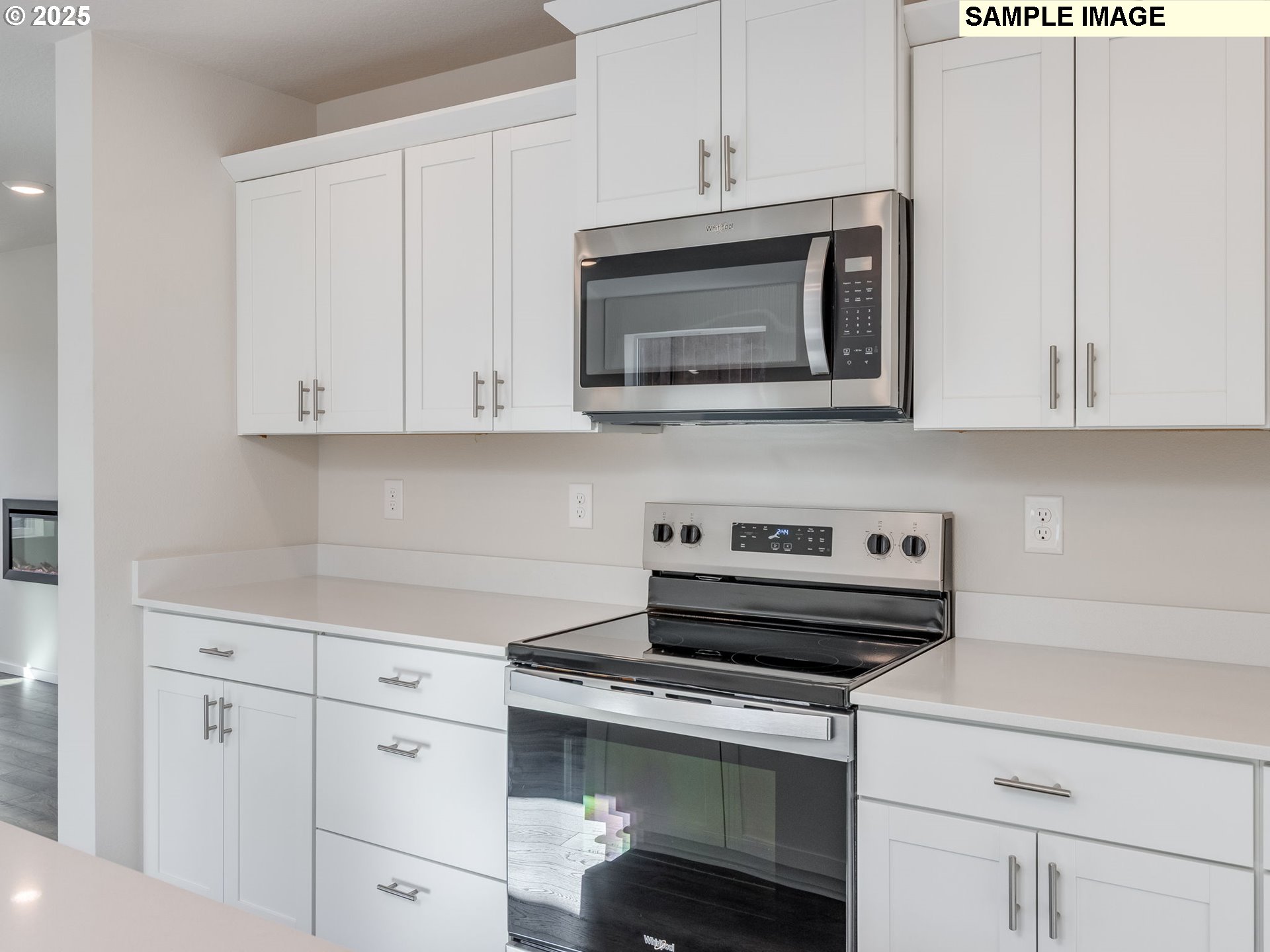 19308 Southeast 11th Way Camas, WA 98607 - Photo 6 of 28 a kitchen with white cabinets and black appliances