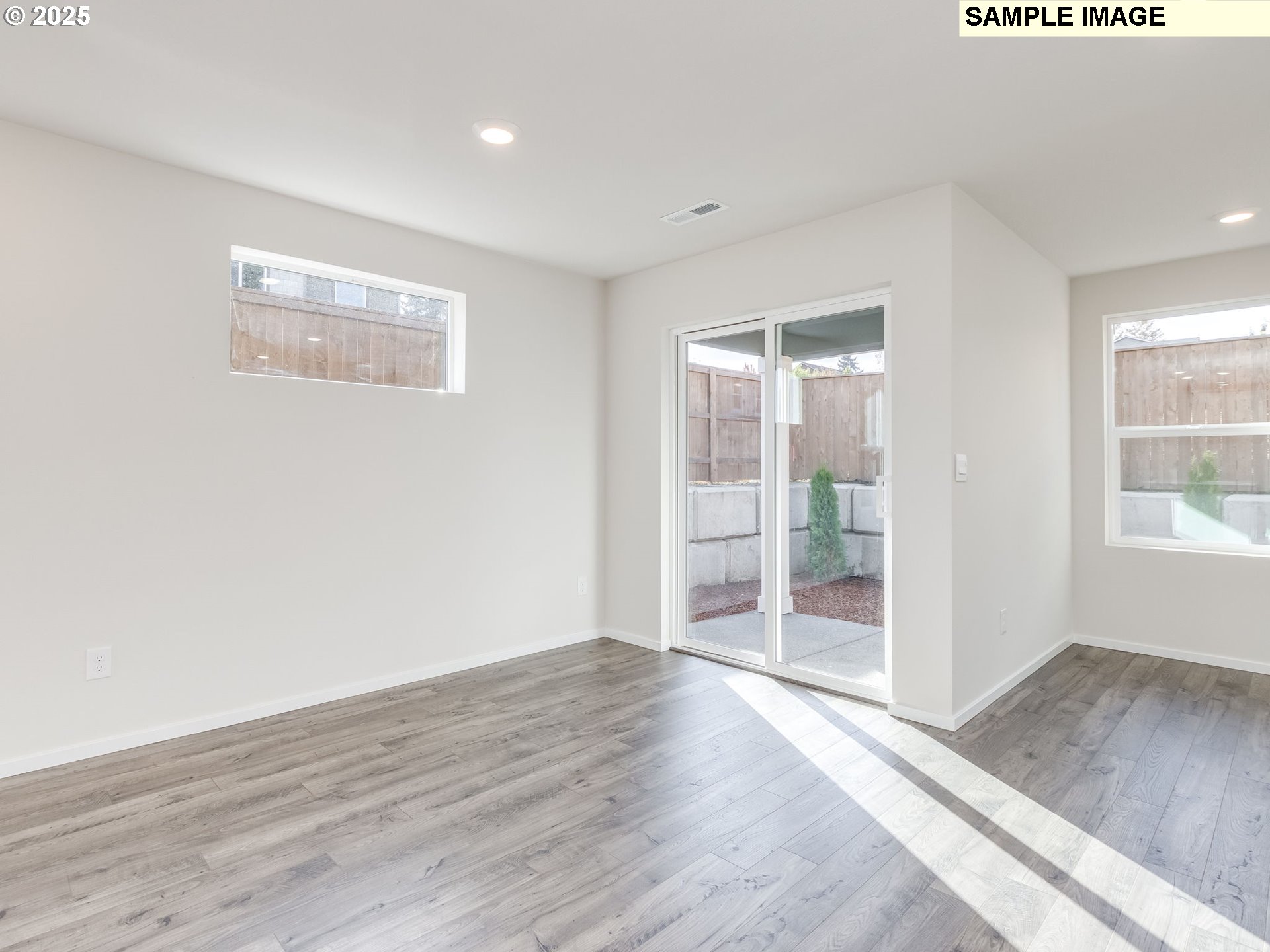 19308 Southeast 11th Way Camas, WA 98607 - Photo 8 of 28 an empty room with wooden floor and windows