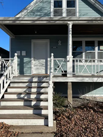 a front view of house with wooden stairs