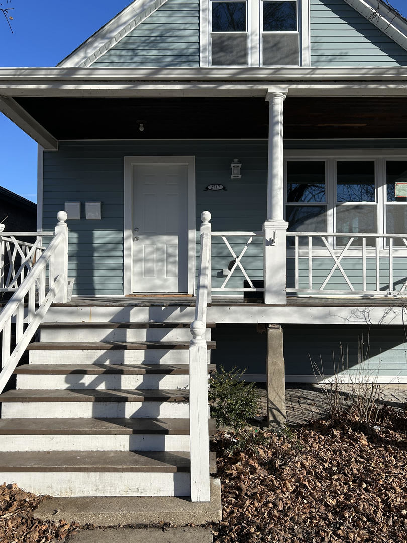 a front view of house with wooden stairs