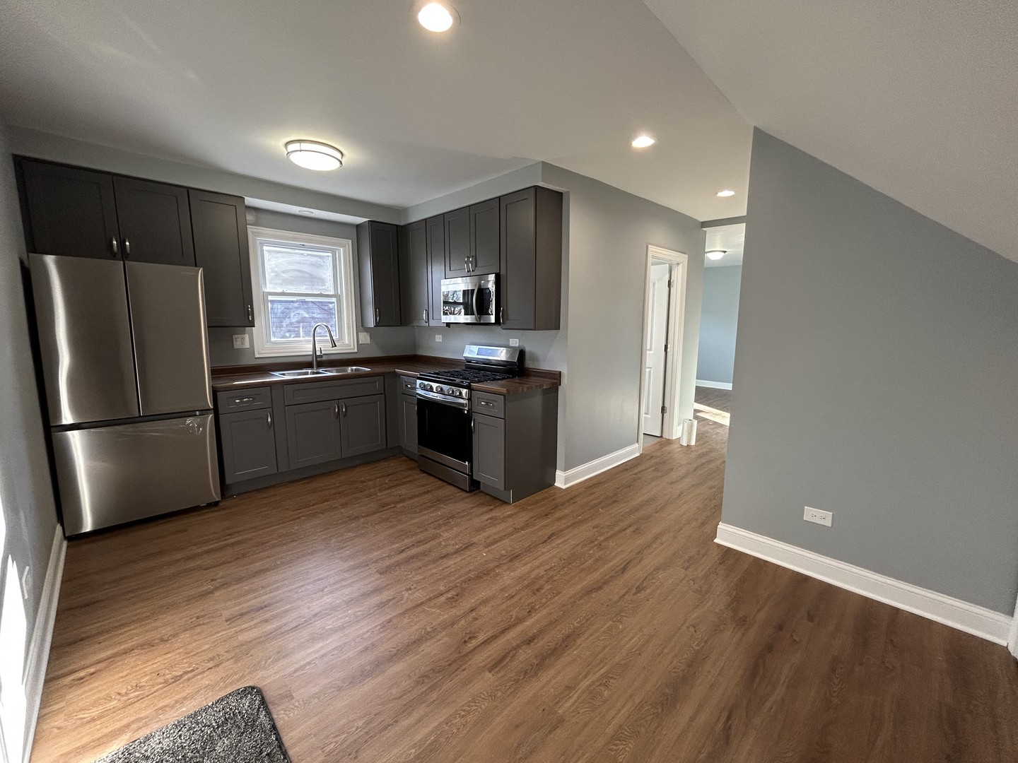 2717 North Rutherford Avenue, Unit 2 Chicago, IL 60707 - Photo 3 of 10 a kitchen with stainless steel appliances granite countertop a refrigerator and a sink