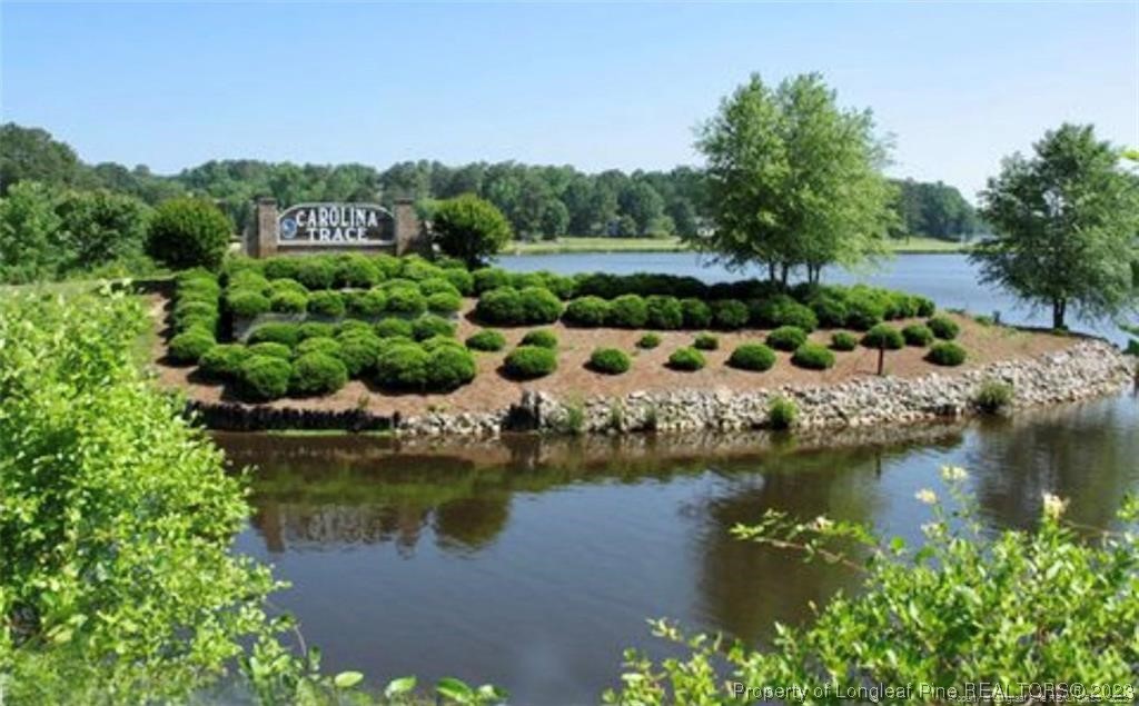 an aerial view of residential houses with outdoor space and lake view