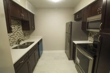 a kitchen with a sink stove and refrigerator