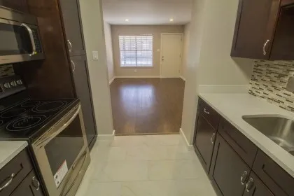 a kitchen with a sink stove and refrigerator