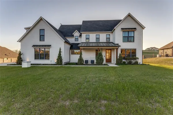 a front view of house with yard and green space