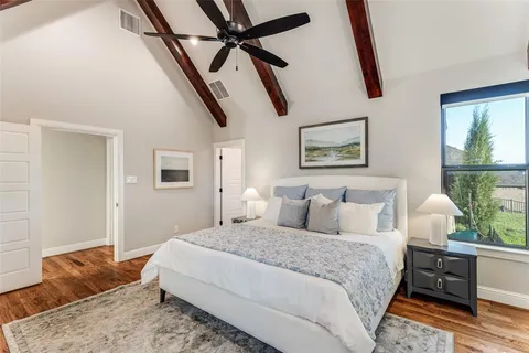 a bedroom with a large bed and a window