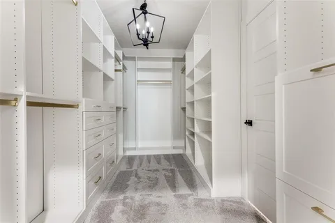 a view of walk in closet with white walls