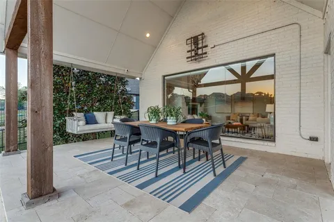 a view of a patio with table and chairs