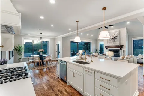 a kitchen with counter space appliances and a view of living room