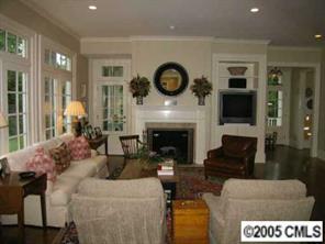 1626 Queens Road Charlotte, NC 28207 - Photo 5 of 8 a living room with furniture a fireplace and a flat screen tv