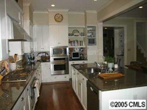1626 Queens Road Charlotte, NC 28207 - Photo 6 of 8 a kitchen with stainless steel appliances granite countertop a sink stove and refrigerator