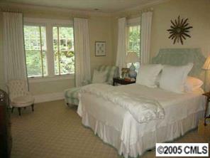 1626 Queens Road Charlotte, NC 28207 - Photo 7 of 8 a bedroom with a bed and a table