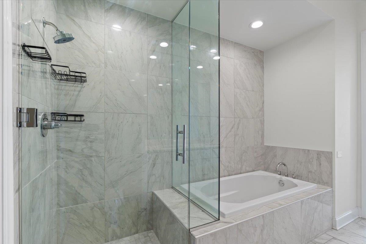 717 Riverside Drive, Unit 906 Memphis, TN 38103 - Photo 11 of 24 Bathroom with a shower stall and a garden tub